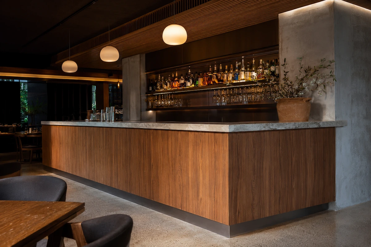 Custom restaurant bar front Melbourne by Northside Joinery, timber veneer bar facade with stone benchtop and integrated refrigeration housing