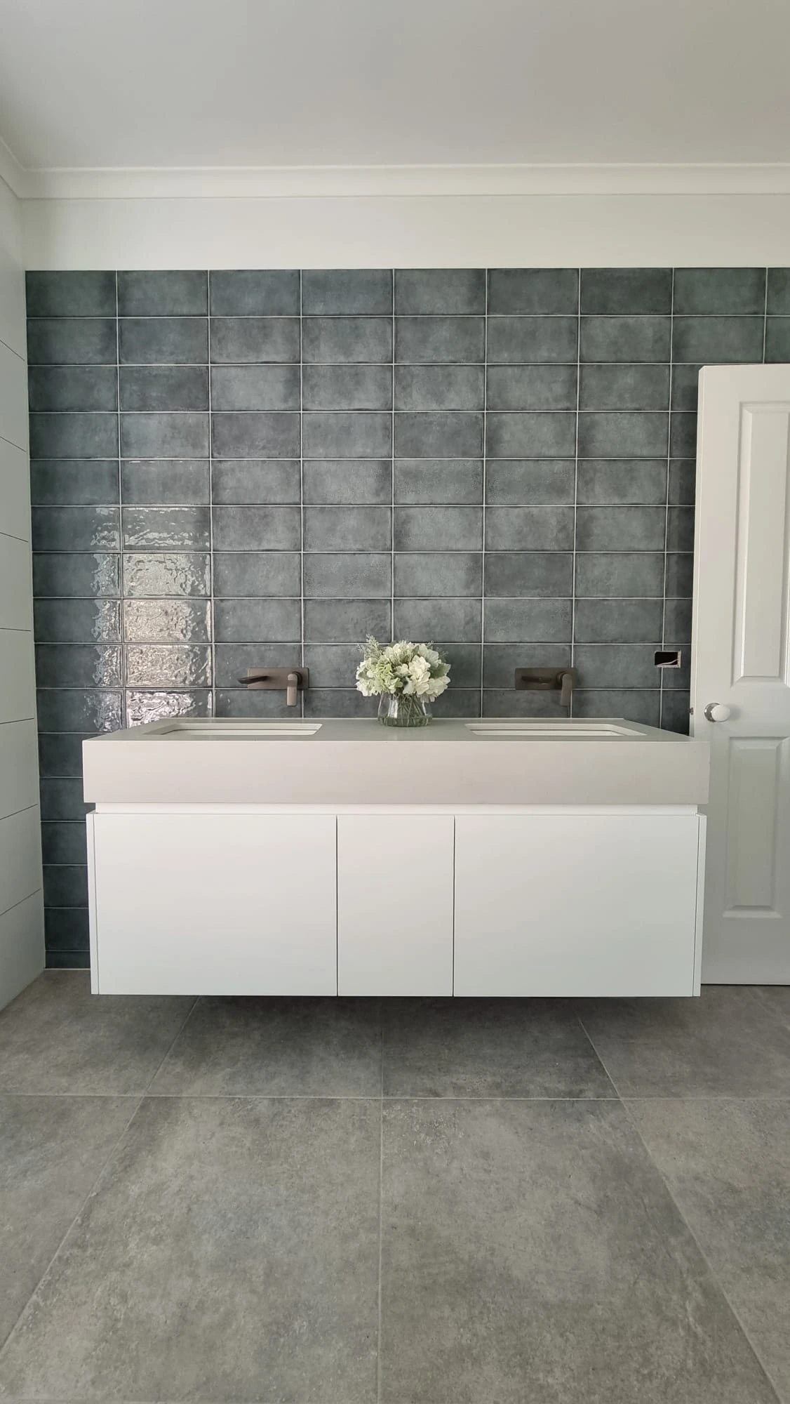 Custom floating bathroom vanity St Helena Melbourne by Northside Joinery, white two-pack doors with undermount basin and drop stone bench