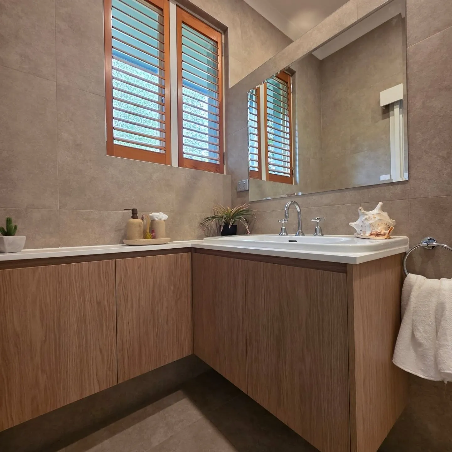Custom bathroom vanity Eaglemont Melbourne by Northside Joinery, warm timber tone veneer doors with stone benchtop