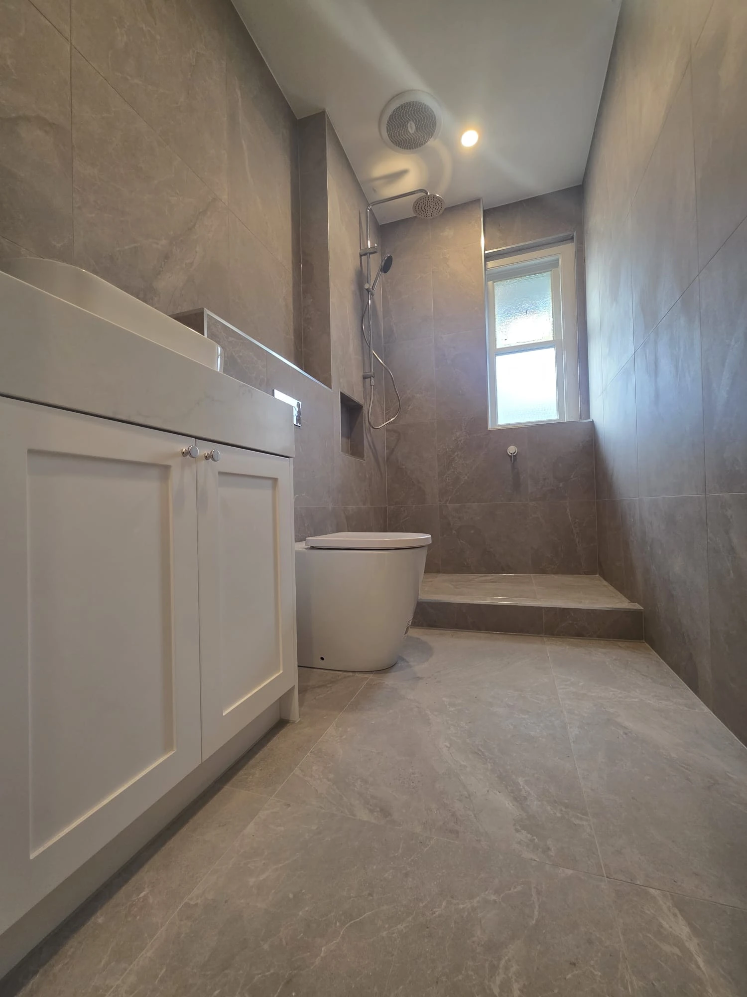 Custom bathroom vanity renovation East Melbourne apartment by Northside Joinery, two-pack shaker doors with 40mm stone benchtop