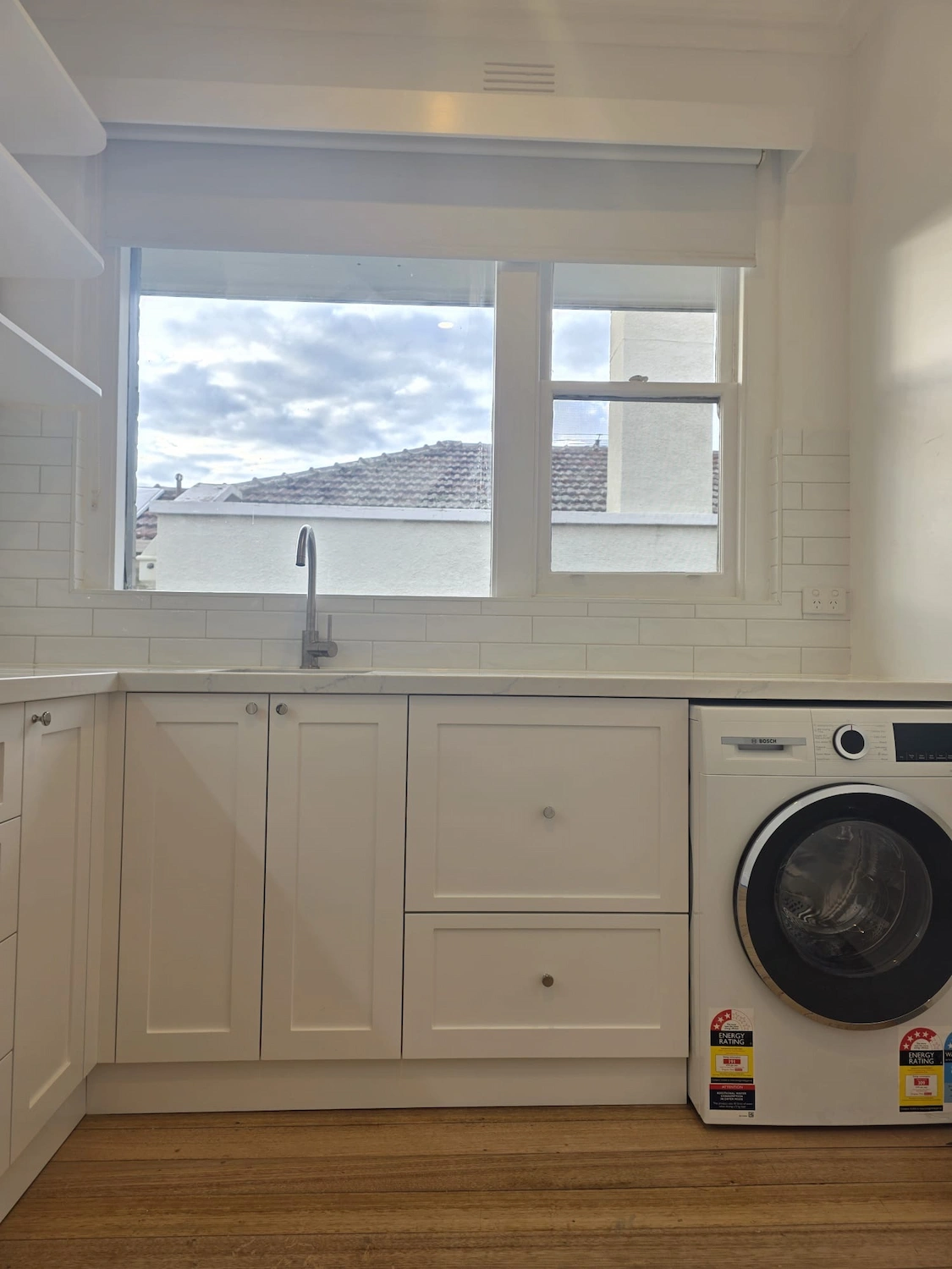 Completed laundry renovation East Melbourne by Northside Joinery, custom joinery with stone benchtop installed after full strip-out