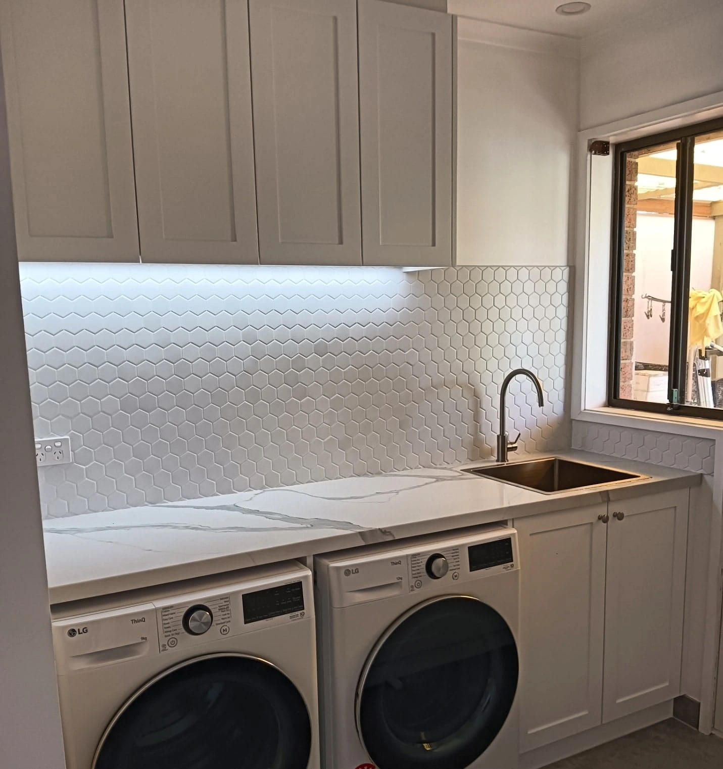 Completed laundry renovation Epping Melbourne by Northside Joinery, custom joinery with stone benchtop