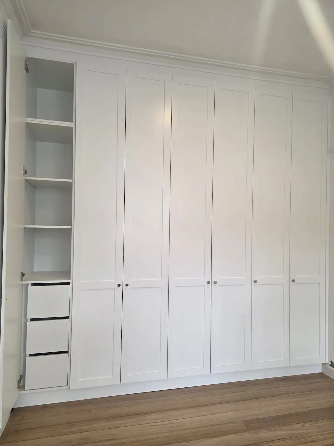 Custom wardrobe internal shelving and drawers in an East Melbourne apartment bedroom by Northside Joinery Melbourne